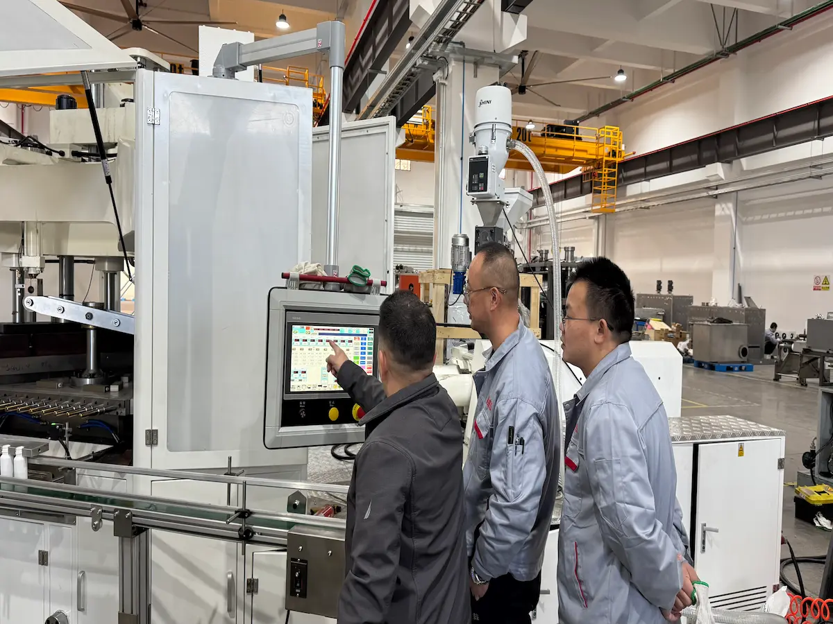 Victor engineers commissioning an injection blow molding machine