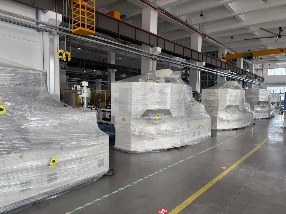 Injection blow molding machines packed on the factory floor at Victor Machinery